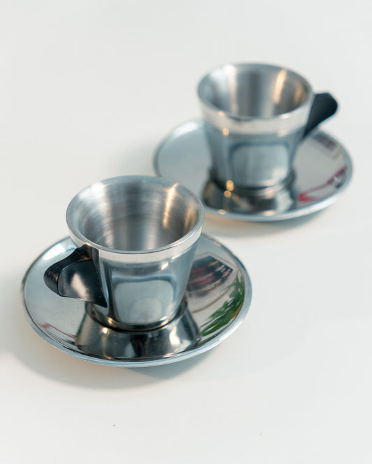 Vintage IKEA double-walled stainless steel espresso cup and saucer set from the 1990s with black plastic handles. Scandinavian minimalist design. Vecino Shop