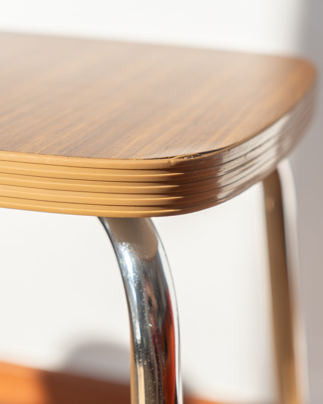 Vintage 1960s mid-century modern wooden laminate stool with shiny chrome legs, simple and elegant design – Vecino Shop.
