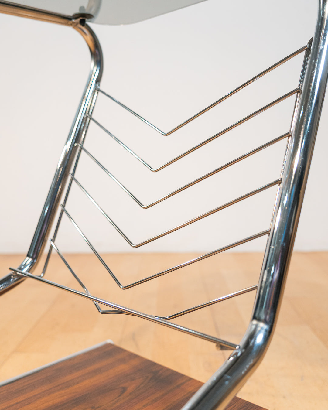 1970s chrome rolling side table with smoked glass top, wooden shelf, wheels, and magazine rack. Vecino Shop