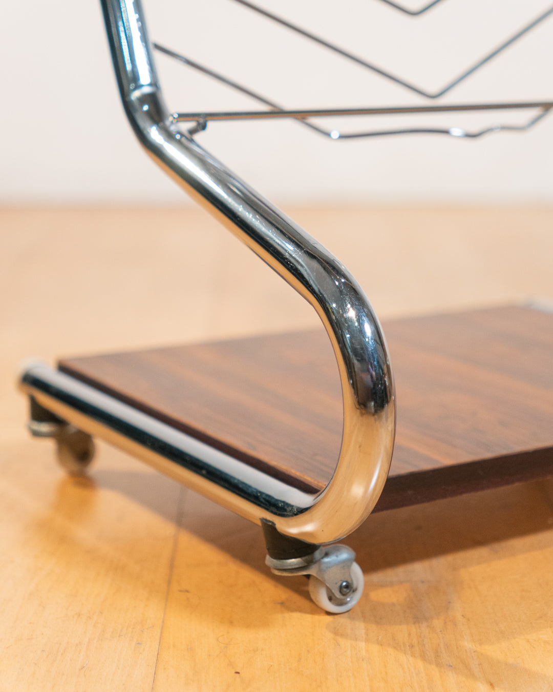 1970s chrome rolling side table with smoked glass top, wooden shelf, wheels, and magazine rack. Vecino Shop