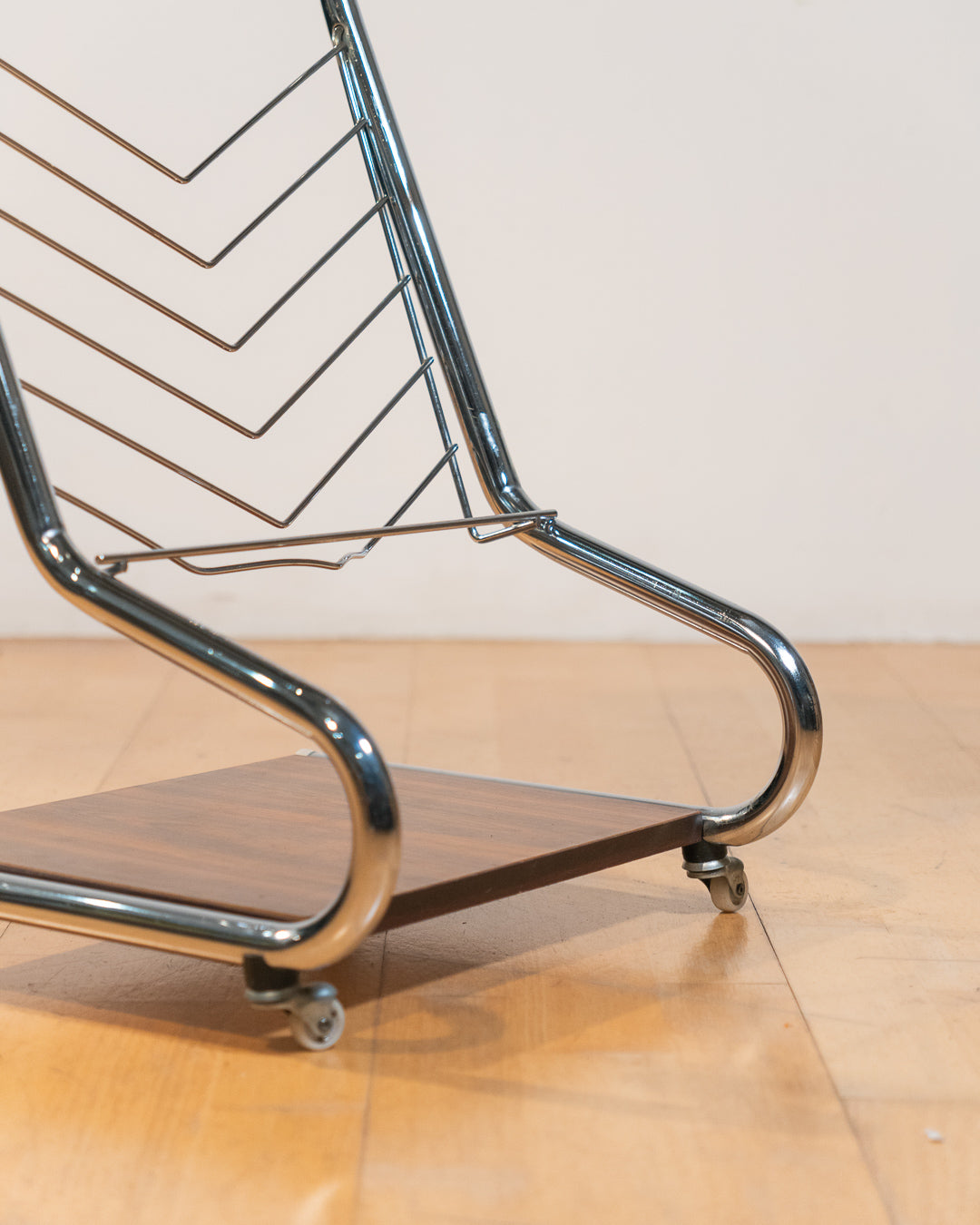 1970s chrome rolling side table with smoked glass top, wooden shelf, wheels, and magazine rack. Vecino Shop
