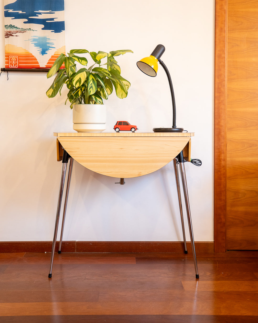 Vintage 1970s folding round table made of light wood-look formica with chrome legs and two drawers