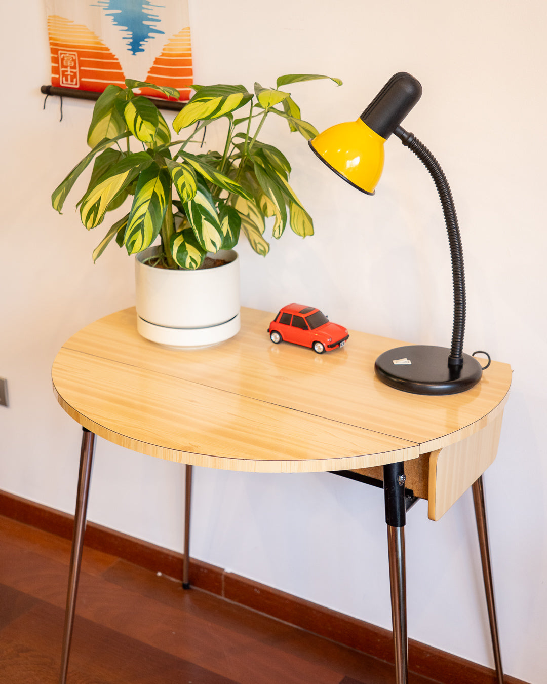 Vintage 1970s folding round table made of light wood-look formica with chrome legs and two drawers