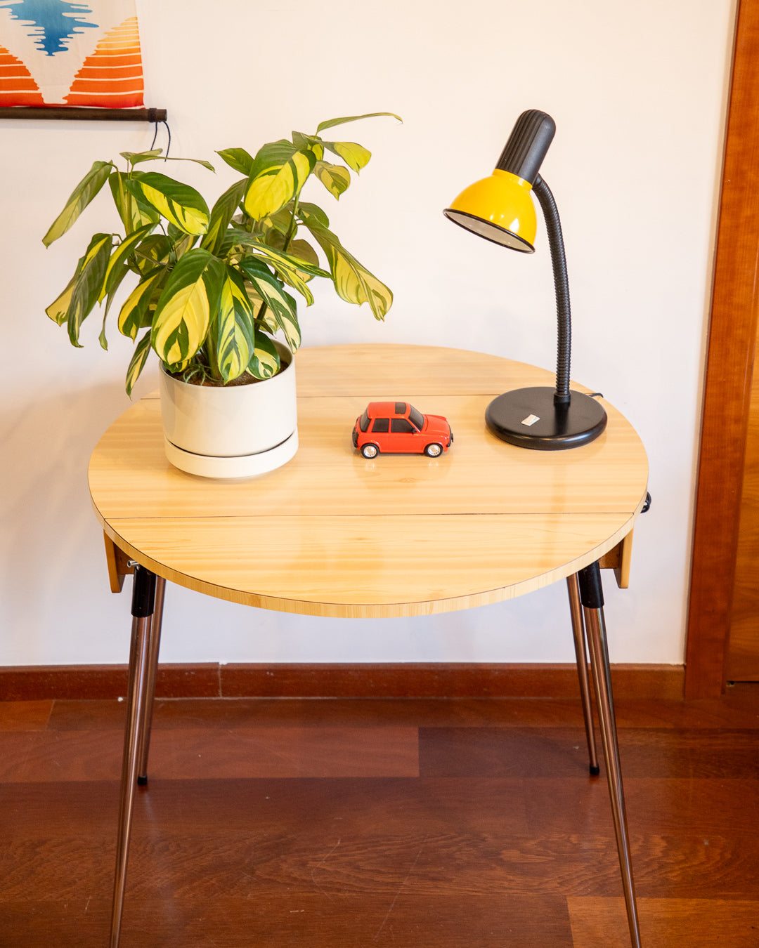 Vintage 1970s folding round table made of light wood-look formica with chrome legs and two drawers