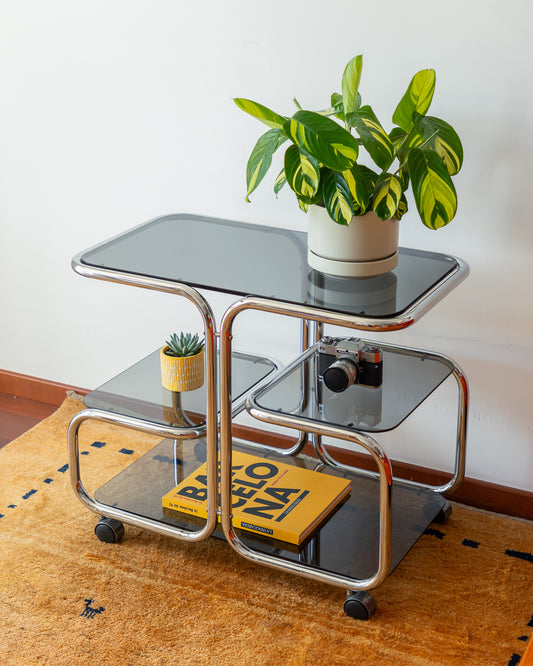 Vintage chrome side table with 4 smoked glass tiers, 1970s, restored and polished, available at Vecino Shop, Barcelona, worldwide shipping.
