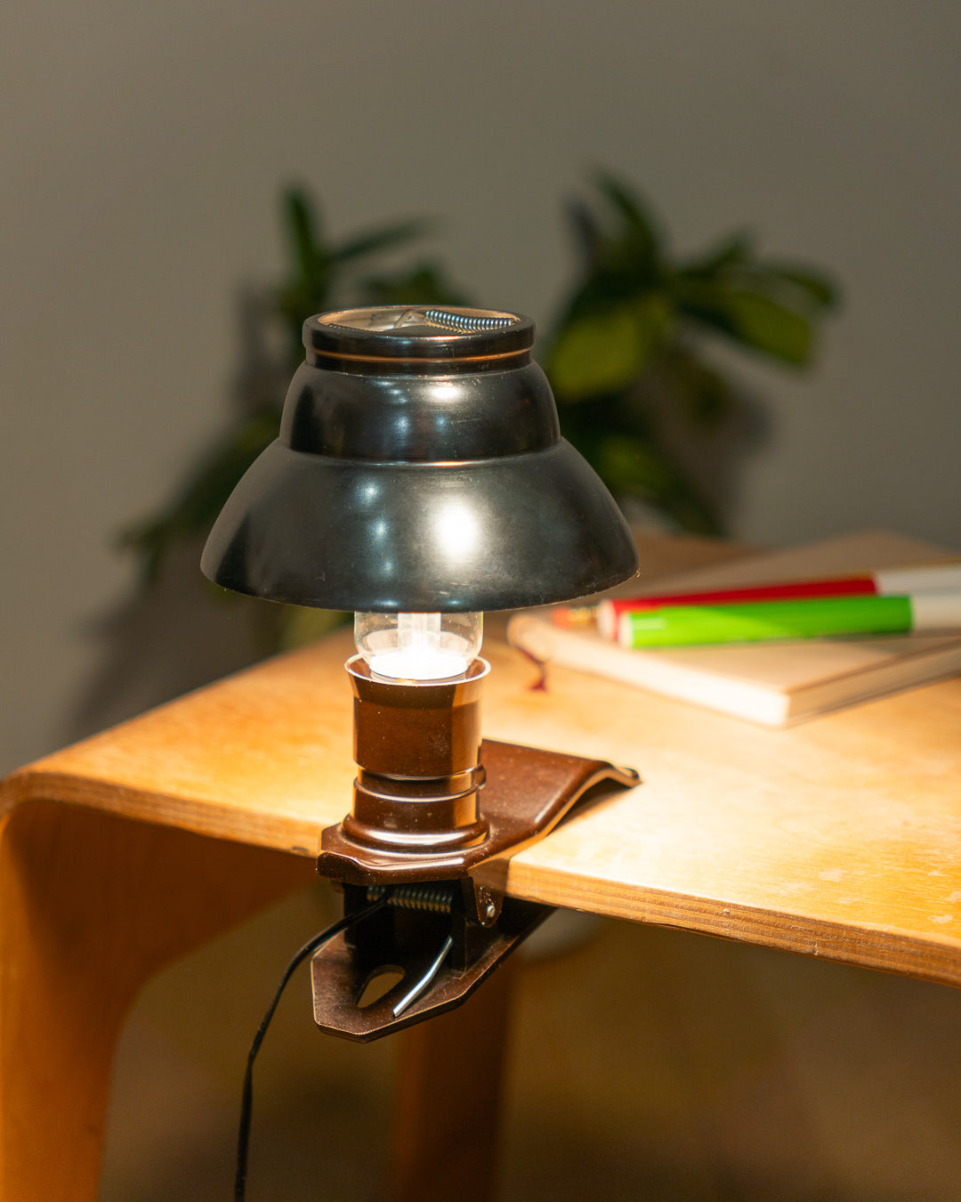 Vintage 1970s aluminum mini mushroom clip lamp with space age design and Bakelite clip base. Compact retro lighting piece from Vecino Shop.