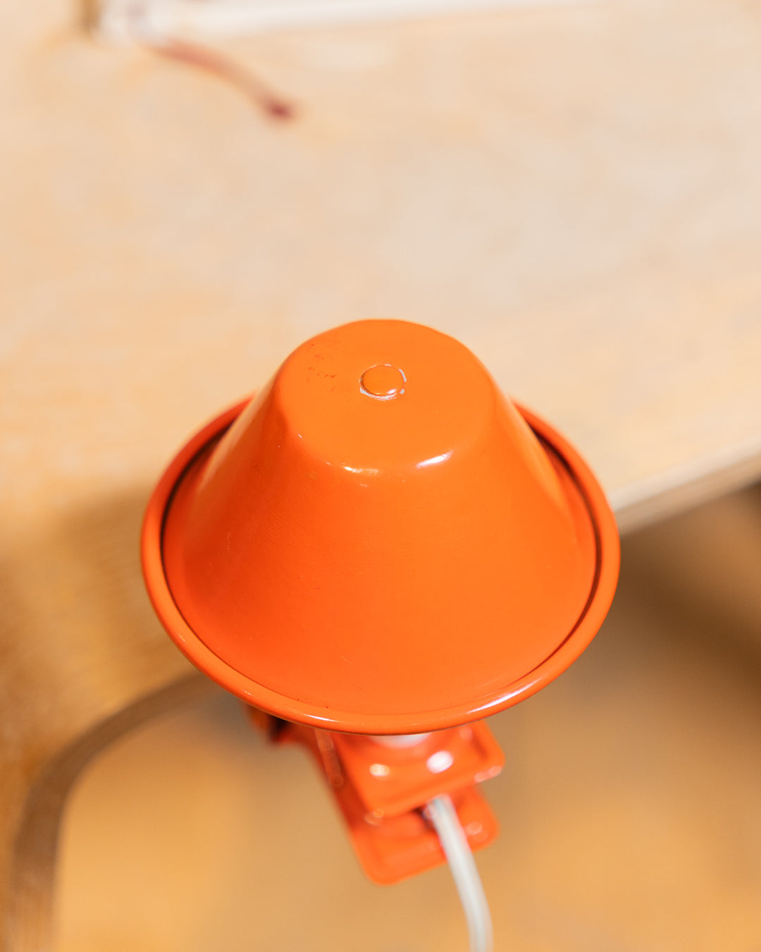 Vintage orange Luxus mushroom clip lamp from the 1970s with white housing and clamp base. Retro space age lighting piece.
