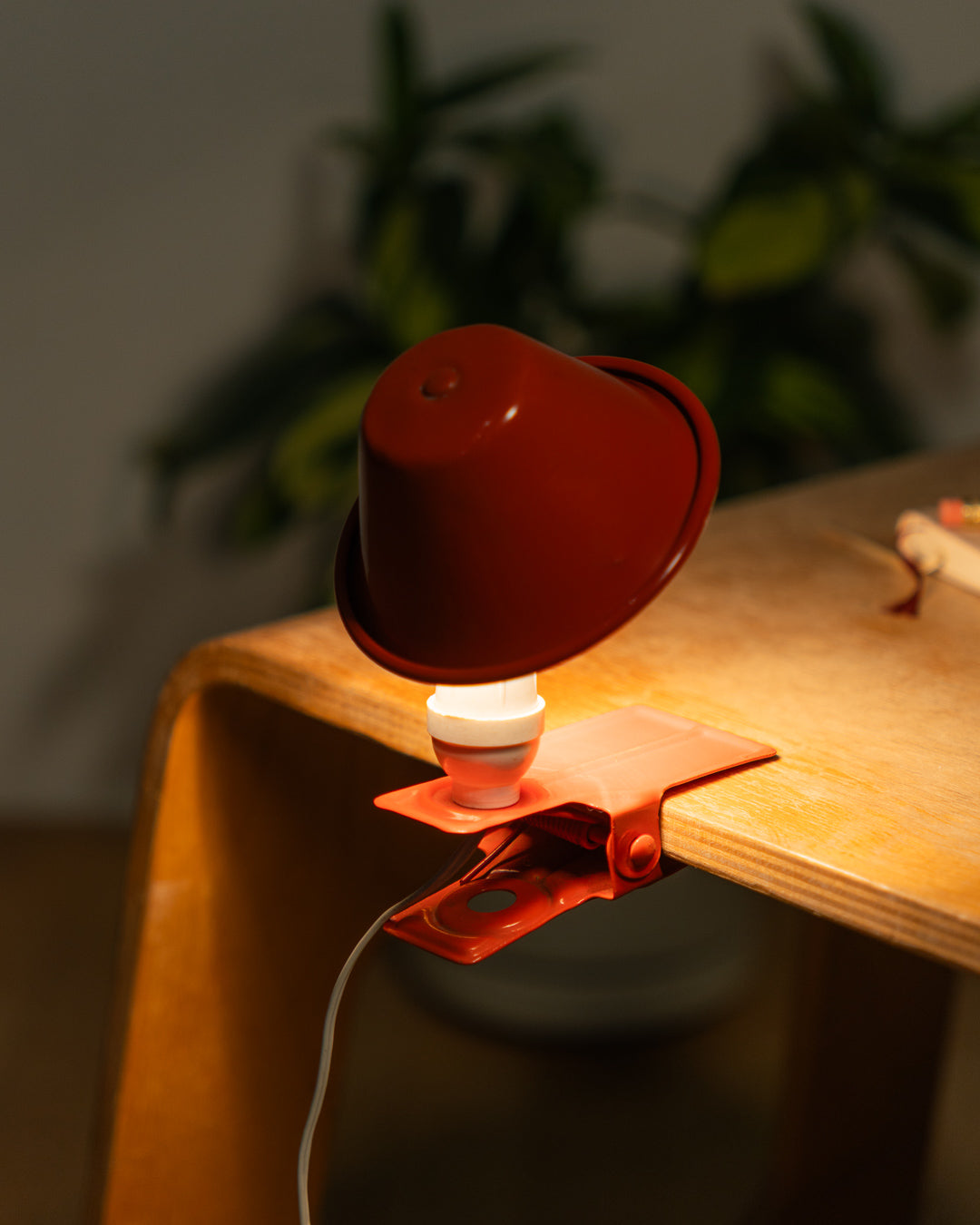 Vintage orange Luxus mushroom clip lamp from the 1970s with white housing and clamp base. Retro space age lighting piece.