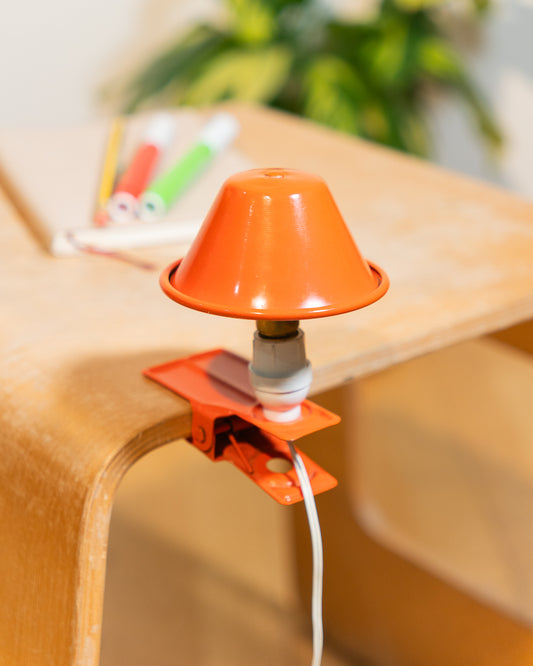 Vintage orange Luxus mushroom clip lamp from the 1970s with white housing and clamp base. Retro space age lighting piece.
