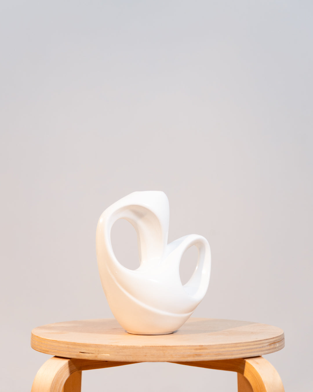Vintage white glazed ceramic abstract vase from the 1980s with double handle detail. Vecino Shop