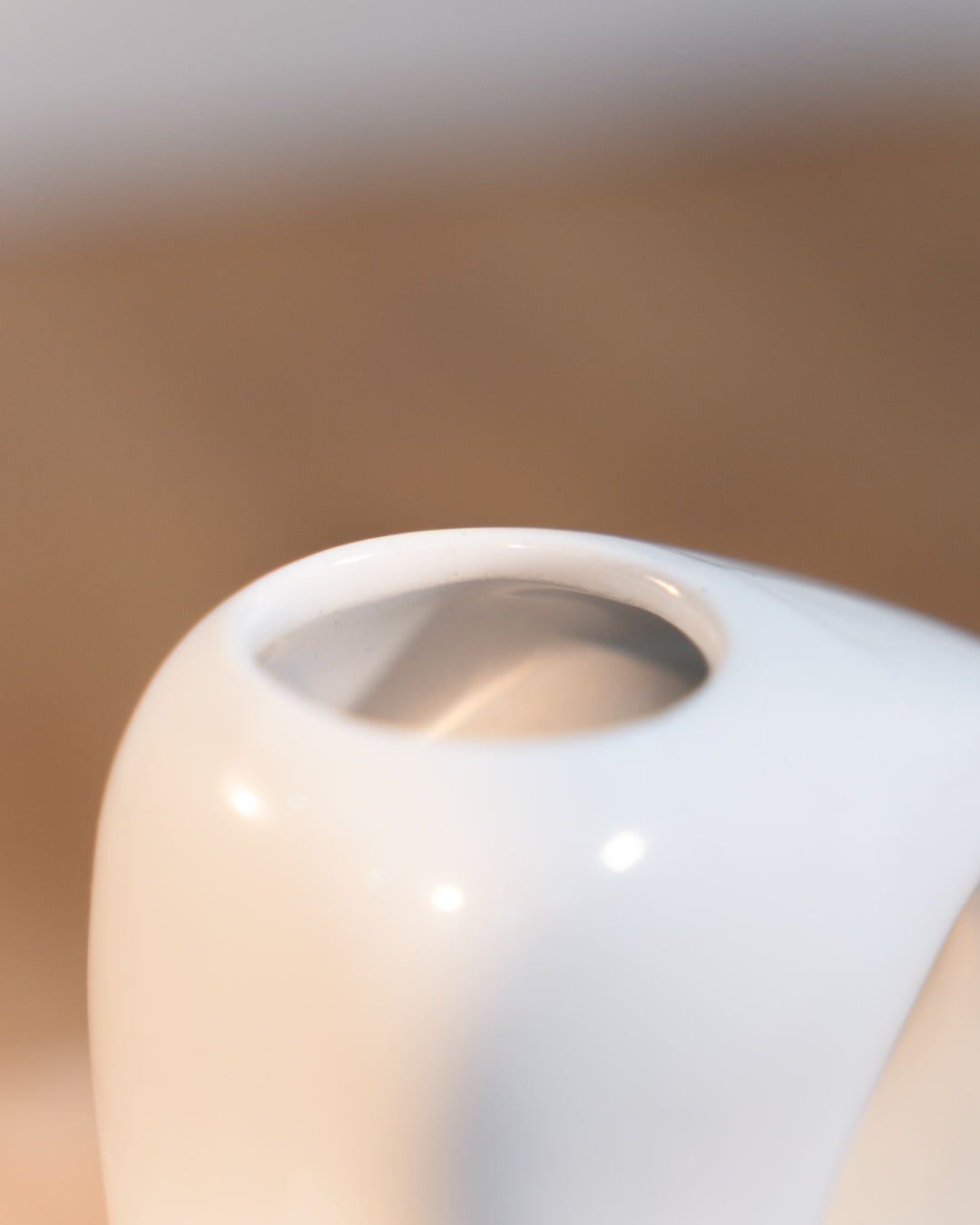 Vintage white glazed ceramic abstract vase from the 1980s with double handle detail. Vecino Shop